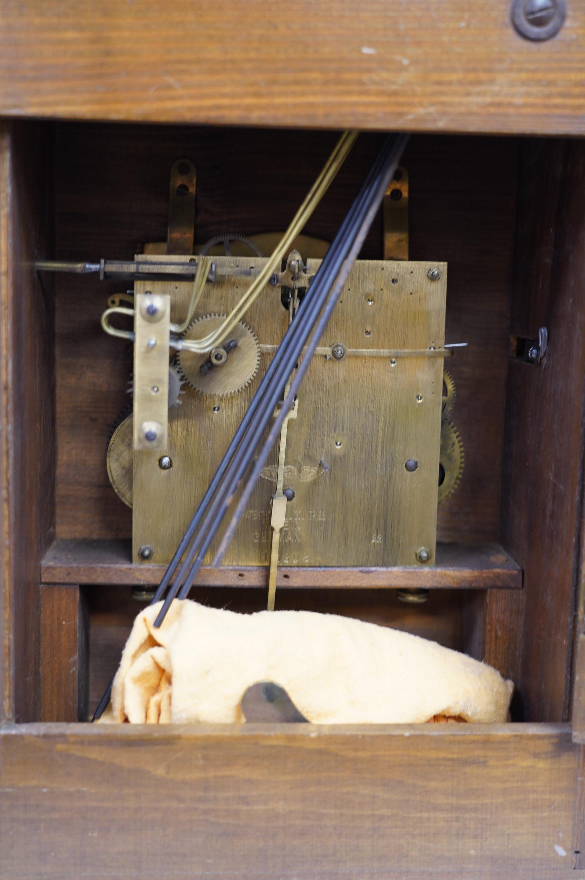 An oak bracket clock with a German three train movement, chiming on five gongs, 47cm high. Condition - fair to good, some wear to chapter ring, etc.